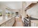 Modern kitchen featuring an open concept layout into the living area with white cabinetry at 9126 Cypress Keep Ln, Odessa, FL 33556