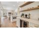Modern kitchen featuring an open concept layout into the living area with white cabinetry and wine fridge at 9126 Cypress Keep Ln, Odessa, FL 33556