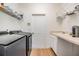 Functional laundry room featuring a modern washer and dryer, ample storage, and a practical sink area with countertop at 9126 Cypress Keep Ln, Odessa, FL 33556
