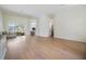 Spacious living room with light wood flooring, abundant natural light, and open access to dining and kitchen spaces at 9126 Cypress Keep Ln, Odessa, FL 33556