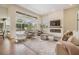 Open-concept living room features a screened-in lanai, cozy seating, and a modern fireplace at 9126 Cypress Keep Ln, Odessa, FL 33556