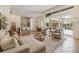Bright, open-concept living space with hardwood floors, stylish furniture, and views of the lanai at 9126 Cypress Keep Ln, Odessa, FL 33556