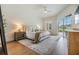 Main bedroom with hardwood floors, neutral décor, and private access to the outdoor patio at 9126 Cypress Keep Ln, Odessa, FL 33556