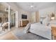 Serene main bedroom with hardwood floors, neutral colors, a ceiling fan, and private lanai access at 9126 Cypress Keep Ln, Odessa, FL 33556
