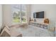 Play room with large window, plush seating, and storage space for books, toys and art supplies at 9126 Cypress Keep Ln, Odessa, FL 33556