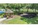Playground and gazebo with benches surrounded by mature trees offering shade and relaxation at 9126 Cypress Keep Ln, Odessa, FL 33556
