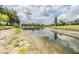 Scenic pond view reflecting the sky, surrounded by lush landscaping and community homes at 9126 Cypress Keep Ln, Odessa, FL 33556