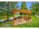 Beautiful backyard with lake views, a wooden pergola, and a swing at 10208 Westpark Preserve Blvd, Tampa, FL 33625