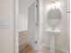 A modern pedestal sink in a neutral-toned half bathroom at 10208 Westpark Preserve Blvd, Tampa, FL 33625