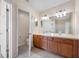Bathroom featuring double sink vanity with large mirror and a separate toilet area at 10208 Westpark Preserve Blvd, Tampa, FL 33625