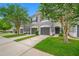 Charming townhouse featuring a well-maintained lawn and gray exterior at 10208 Westpark Preserve Blvd, Tampa, FL 33625