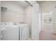 Well-lit laundry room with a washing machine and dryer at 10208 Westpark Preserve Blvd, Tampa, FL 33625