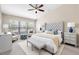 Primary bedroom with sitting area offers large window and a ceiling fan at 10208 Westpark Preserve Blvd, Tampa, FL 33625