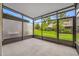 Enclosed patio area with a concrete floor and screened walls at 10208 Westpark Preserve Blvd, Tampa, FL 33625