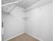 Walk-in closet featuring wire shelving and neutral carpet at 10208 Westpark Preserve Blvd, Tampa, FL 33625