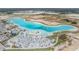 Gorgeous aerial showcasing the lagoon's beach area with loungers, umbrellas, and amenities at 10278 Otter Sky Ct, San Antonio, FL 33576