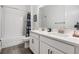 Bright bathroom with double sinks, white subway tile shower, and modern fixtures at 10278 Otter Sky Ct, San Antonio, FL 33576