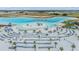 Wide aerial of the lagoon's beach, featuring white sand, lounge chairs, and palm trees at 10278 Otter Sky Ct, San Antonio, FL 33576