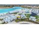 Aerial shot displaying the community's clubhouse and recreational amenities by the stunning lagoon at 10278 Otter Sky Ct, San Antonio, FL 33576