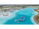 Aerial view of a stunning turquoise lagoon-style pool with an inflatable obstacle course at 10278 Otter Sky Ct, San Antonio, FL 33576
