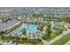 Aerial view of community clubhouse, pool, tennis, bocce ball courts in a neighborhood at 10278 Otter Sky Ct, San Antonio, FL 33576