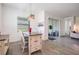 Bright dining area features a modern light fixture, wood-look tile floors, and a sliding glass door at 10278 Otter Sky Ct, San Antonio, FL 33576