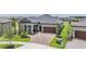 Inviting exterior showcasing the home's well-maintained lawn, brick driveway, mature trees, and classic architectural details at 10278 Otter Sky Ct, San Antonio, FL 33576