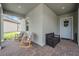 Inviting front porch area with rocking chairs and a bench, perfect for relaxing and enjoying the outdoors at 10278 Otter Sky Ct, San Antonio, FL 33576
