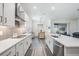Modern kitchen with white cabinetry, sleek countertops, and stainless steel appliances, ideal for cooking at 10278 Otter Sky Ct, San Antonio, FL 33576