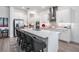 Bright kitchen with stainless appliances, stylish backsplash, and an expansive island with seating at 10278 Otter Sky Ct, San Antonio, FL 33576