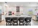Open-concept kitchen with a large island, modern lighting, and stainless steel appliances at 10278 Otter Sky Ct, San Antonio, FL 33576