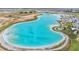 Stunning aerial view of a large, clear turquoise lagoon, perfect for swimming and recreational activities at 10278 Otter Sky Ct, San Antonio, FL 33576