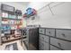 Well-organized laundry room featuring washer, dryer, shelving, and drawers for efficient storage and space-saving solutions at 10278 Otter Sky Ct, San Antonio, FL 33576