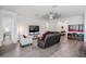 Bright and airy living room with sleek furniture, modern décor, and wood-style flooring at 10278 Otter Sky Ct, San Antonio, FL 33576