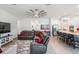 Inviting living room with modern sofa, stylish rug, and open access to the kitchen area at 10278 Otter Sky Ct, San Antonio, FL 33576