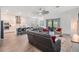 Open-concept living room with modern furnishings, a ceiling fan, and a view of the kitchen and patio at 10278 Otter Sky Ct, San Antonio, FL 33576