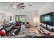 Spacious living room featuring modern furniture and a large television for entertaining at 10278 Otter Sky Ct, San Antonio, FL 33576