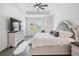 Elegant main bedroom featuring a tray ceiling, plush bed, and a large TV for ultimate comfort at 10278 Otter Sky Ct, San Antonio, FL 33576