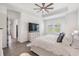 Elegant main bedroom featuring a tray ceiling, plush bed, and a large TV for ultimate comfort at 10278 Otter Sky Ct, San Antonio, FL 33576