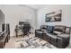 Well-lit office features a comfortable leather couch, an elegant picture and dual monitor setup at 10278 Otter Sky Ct, San Antonio, FL 33576