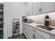 Butler's pantry featuring open shelves, lots of closed storage, and quartz countertops at 10278 Otter Sky Ct, San Antonio, FL 33576