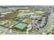 An aerial view of community tennis courts and recreation areas surrounded by lush landscaping at 10278 Otter Sky Ct, San Antonio, FL 33576