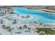 Aerial view of the lagoon's water park, with slides, a sandy beach, and recreational facilities at 10278 Otter Sky Ct, San Antonio, FL 33576