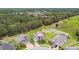 Aerial view of an upscale neighborhood featuring green spaces, ponds, and stylish homes at 10701 Morning Dew Way, Tampa, FL 33647
