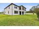 Expansive green backyard featuring a covered patio and balcony in the rear of this two-story home at 10701 Morning Dew Way, Tampa, FL 33647