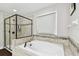 Bathroom showcases walk-in glass shower, garden tub, and tile floors at 10701 Morning Dew Way, Tampa, FL 33647