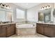 A luxurious bathroom boasting a corner tub and dual vanity sinks at 10701 Morning Dew Way, Tampa, FL 33647