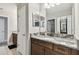 Bathroom features granite countertops, and sinks and white cabinetry at 10701 Morning Dew Way, Tampa, FL 33647