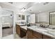 Bathroom featuring dual sinks with granite countertops and tile floors at 10701 Morning Dew Way, Tampa, FL 33647