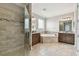 Spacious bathroom with glass shower enclosure and corner soaking tub at 10701 Morning Dew Way, Tampa, FL 33647